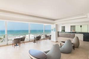 a living room with a view of the ocean at Al Hail Waves Hotel Managed By Centara in Seeb