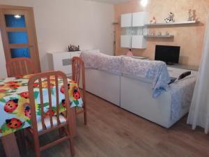 a bedroom with a bed and a table and chairs at Apartamento El Prado in Almazán