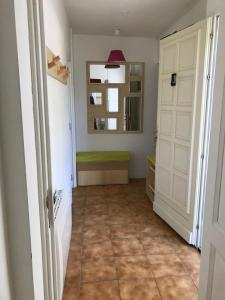 a hallway with a room with a door and a mirror at Gîte L’oliveraie D’Aniane 2 personnes in Aniane +6 photos