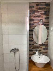 a bathroom with a sink and a mirror at Holiday Home Tunnel Ravne in Visoko
