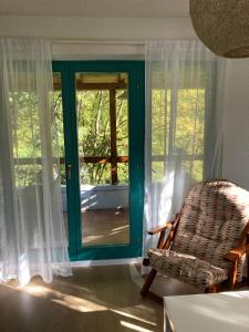 a room with a door and a chair and a window at Holiday Home Tunnel Ravne in Visoko