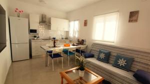 a kitchen and living room with a couch and a table at alquilaencanarias Casa La Playa La Gomera in Alojera +29 photos