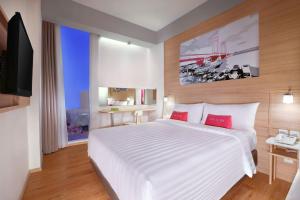 Postel nebo postele na pokoji v ubytování favehotel Palembang