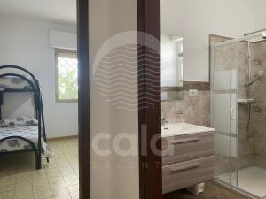 a bathroom with a shower and a sink at Villa Tortuga By Cala Salento in Torre Lapillo +22 photos