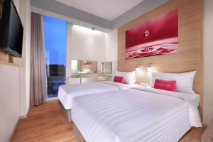 Postel nebo postele na pokoji v ubytování favehotel Palembang