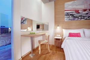Postel nebo postele na pokoji v ubytování favehotel Palembang