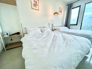 a bedroom with two beds with white sheets at D 1-5Pax Cozy Home Trefoil Setia Alam 3bed Wifi &TV Shah Alam Setia City Mall in Setia Alam