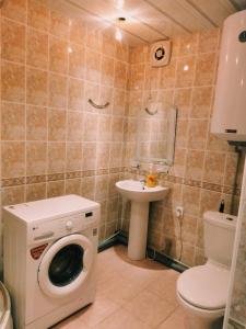 a bathroom with a washing machine and a sink at Apartment on Abazgaa 53-4 in Gagra