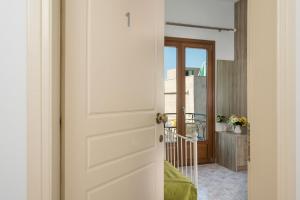 a door leading into a room with a balcony at Porto Orion Studios in Chania Town