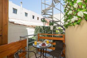 a patio with a table and chairs on a balcony at Porto Orion Studios in Chania Town