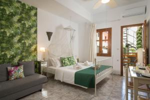 a bedroom with a bed and a couch at Porto Orion Studios in Chania Town