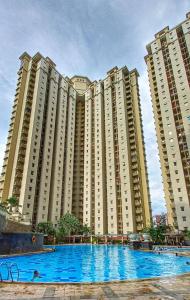 a large apartment building with a large swimming pool at Mediterania palace residences kemayoran in Jakarta