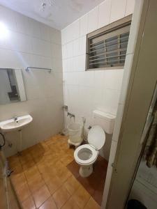 a small bathroom with a toilet and a sink at Sri Durgamba Lodge in Bangalore