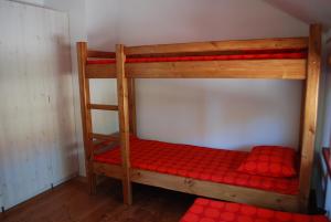 a set of bunk beds with red sheets at Hostel Pritsukas in Orissaare