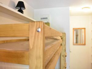 um beliche de madeira num quarto com um espelho em Appartement Méribel, 1 pièce, 4 personnes - FR-1-180-26 em Méribel