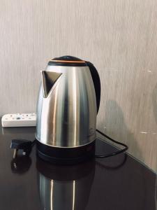 a coffee pot is sitting on a table at Summer Suites in George Town