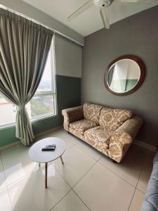 a living room with a couch and a mirror at Summer Suites in George Town