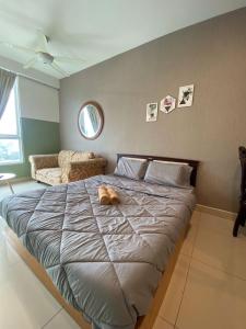 a dog laying on a bed in a bedroom at Summer Suites in George Town