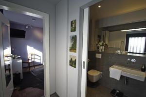 a bathroom with a sink and a toilet and a mirror at quartier26 in Nürnberg