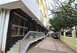 a building with stairs in front of a street at Hotel Pandian in Chennai