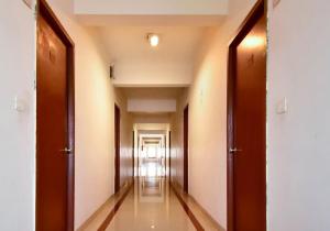 an empty corridor of an office building with wooden doors at Hotel Pandian in Chennai