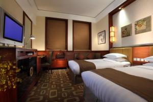 Giường trong phòng chung tại Min Zu Hotel