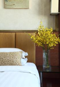 Postel nebo postele na pokoji v ubytování Min Zu Hotel