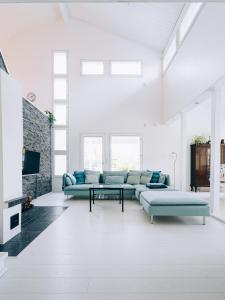 a living room with blue couches and a tv at Villa Snow White in Rovaniemi