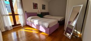a small room with two beds and a mirror at Adria Beach Apartment in Cavallino-Treporti