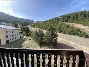 a balcony with a view of a hill with trees at Appartement Les Angles, 2 pièces, 4 personnes - FR-1-295-137 in Les Angles