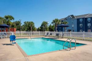 a swimming pool at a apartment complex at Comfort Inn Pensacola near NAS Corry Station in Pensacola