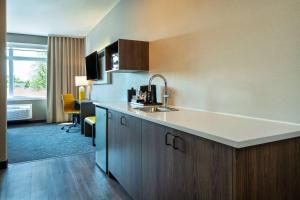 a kitchen with a sink and a counter top at Comfort Inn & Suites in Kingston