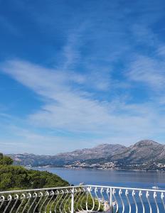 a bridge over a body of water with mountains at Villa Stanović Tea in Cavtat