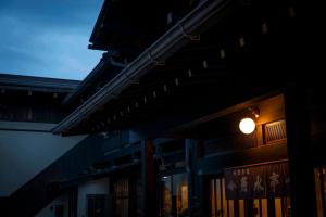 a building with a light on the side of it at Busuitei in Hida