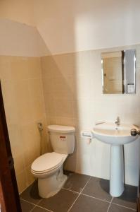 a bathroom with a toilet and a sink at HideSeek Hostel Vientiane Thai embassy in Vientiane