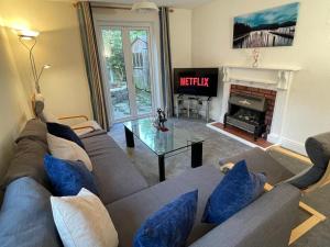 uma sala de estar com um sofá e uma lareira em 3-bedroom home with free parking em Canterbury