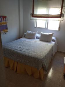 a bedroom with a bed with two pillows and a window at El Valle in Murcia