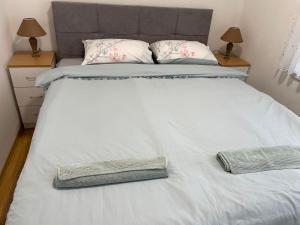 a large white bed with two pillows on it at SIMIKIC Z in Bijeljina