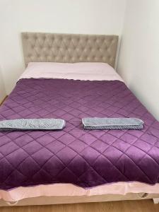 a purple bed with two pillows on it at SIMIKIC Z in Bijeljina