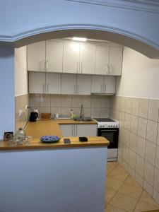 a kitchen with white cabinets and a counter top at SIMIKIC Z in Bijeljina
