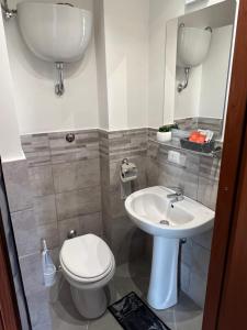 a bathroom with a toilet and a sink at Saint Peter Vatican City confortable Apartament Stellasia casa vacanza in Rome +27 photos