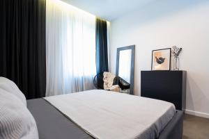 A bed or beds in a room at The Grey Apartment