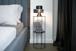A bed or beds in a room at The Grey Apartment