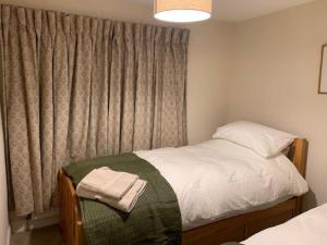 a small bedroom with a bed and a window at Cwmbach Cottage nr Hay on Wye in Glasbury