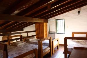 a room with three bunk beds and a window at Vista del sol in Villa Ciudad Parque