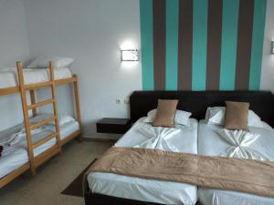 a bedroom with two beds and a bunk bed at Hotel Diar Meriam in Sousse
