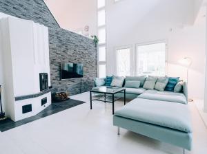 a living room with a couch and a table at Villa Snow White in Rovaniemi