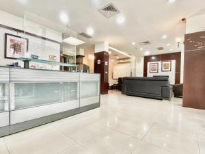 a lobby with a reception desk and a couch at Royal Business Hotel in Hsinchu City