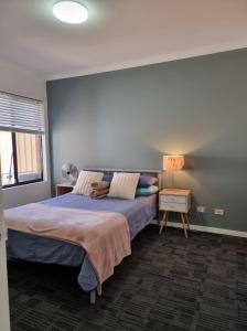 a bedroom with a large bed and a window at Park View Holiday Getaway in Perth