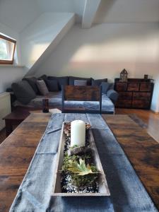 a living room with a table with a candle on it at Gemütliche Ferienwohnung im Harz in Bad Grund